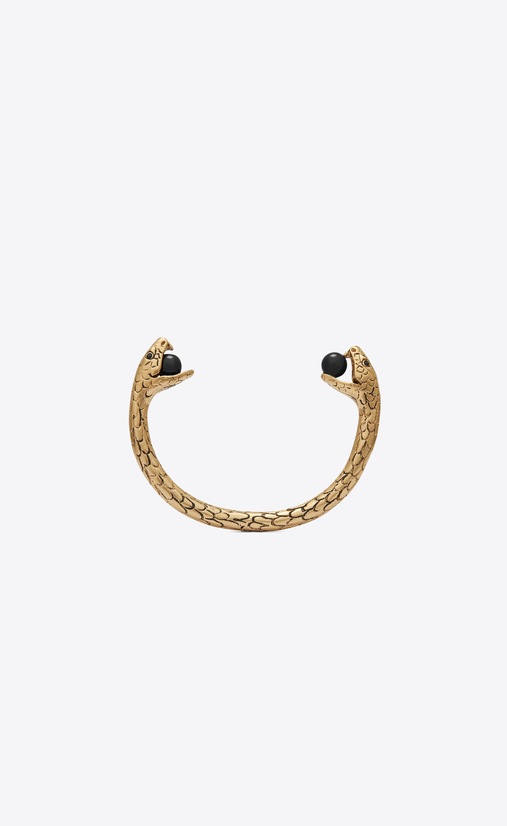 Snake bracelet in gold metal with black glass beads.